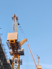 Under construction residential building with Concreate Block structure and Fixed Tower Crane.
Exterior viewHighrise Multistory building modern design,
Yellow Fixed Tower Crane and erected Scaffolding.