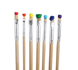 Brushes with different paints isolated on white