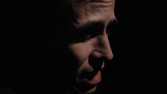 Man speak rudely in a dark room