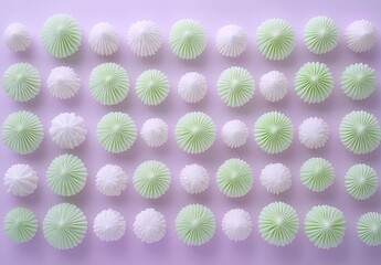Light green and white meringues arranged in a grid pattern on a lavender background.  Each meringue has a cone-shaped top and radial pattern