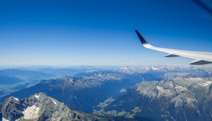 High mountain peaks seen from an airplane window