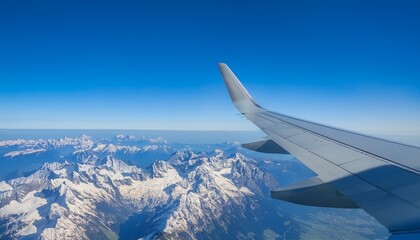 High mountain peaks seen from an airplane window
