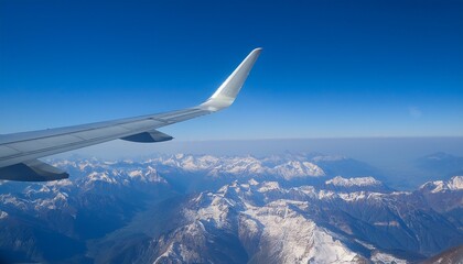 High mountain peaks seen from an airplane window
