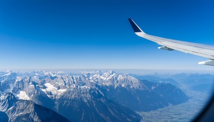High mountain peaks seen from an airplane window