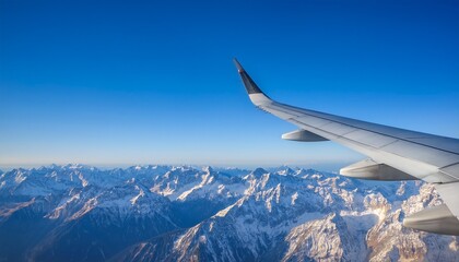 High mountain peaks seen from an airplane window