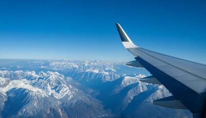 High mountain peaks seen from an airplane window