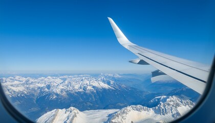 High mountain peaks seen from an airplane window