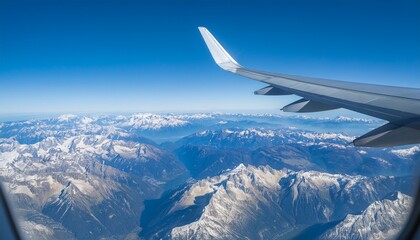 Obraz premium High mountain peaks seen from an airplane window