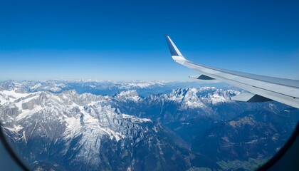 High mountain peaks seen from an airplane window