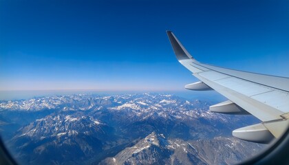 High mountain peaks seen from an airplane window