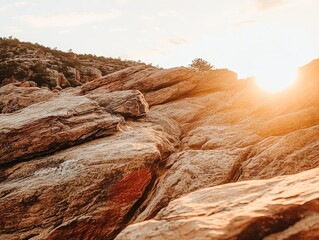 Golden sunlight illuminates rugged mountain rocks.
