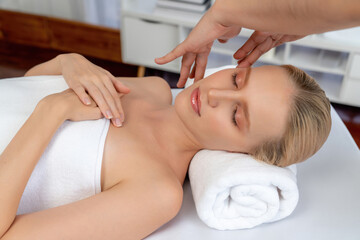 Caucasian woman enjoying relaxing anti-stress head massage and pampering facial beauty skin recreation leisure in dayspa modern light ambient at luxury resort or hotel spa salon. Quiescent