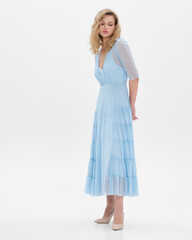 Naklejka premium Girl model in blue dress on white studio background.