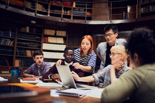 Young and diverse group of students studying in a university library