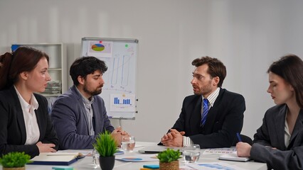 Business Meeting with Four People in Office Setting