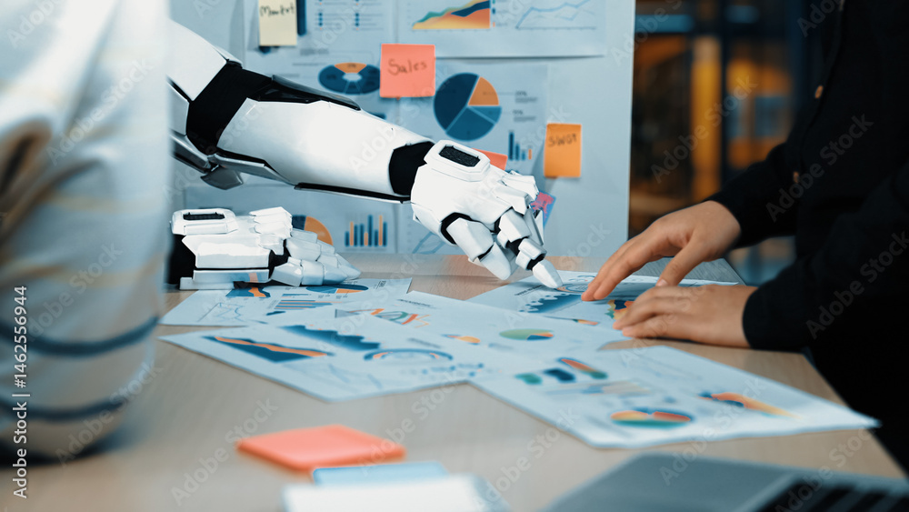 Poster a robotic hand collaborates with a human in analyzing data charts and graphs, showcasing modern tech