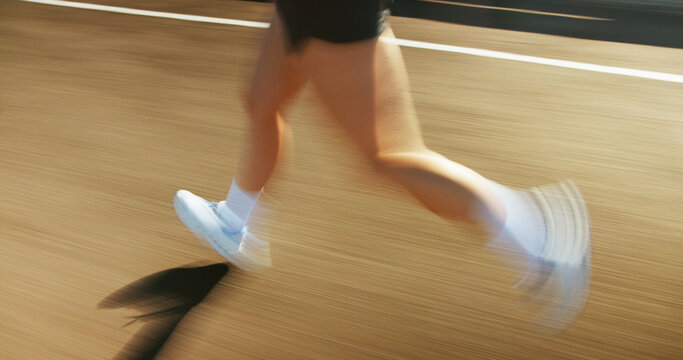 Motion blur, fitness and legs of person running on bridge in city for race, marathon or training. Sports, fast and feet of athlete on highway with cardio workout, challenge or exercise in town.