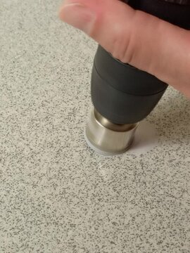 rotating diamond-coated hole saw in drill drills stone slab