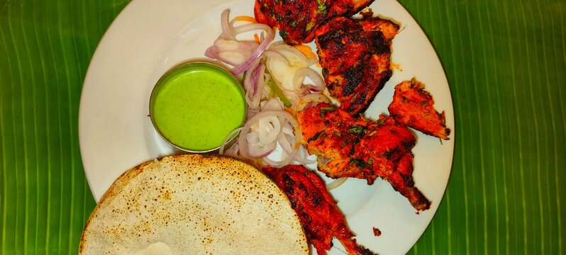  a plate of Tandoori Chicken with , a popular Indian dish