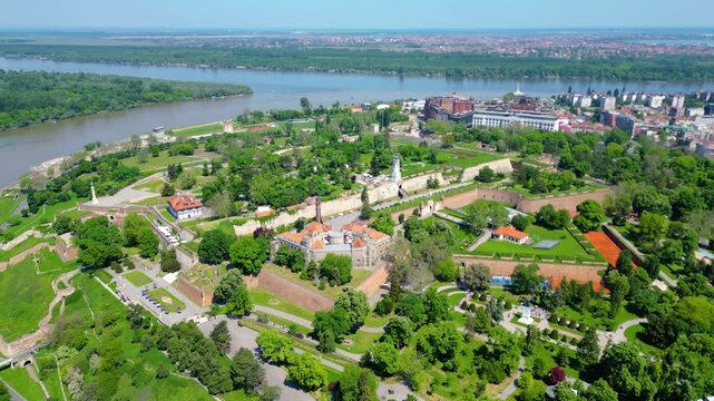 Aerial view of Belgrade where the Sava and Danube rivers meet. Visible landmarks include Kalemegdan Fortress (Beogradska tvrđava), city bridges, and U&scaron;će Park &mdash; a perfect urban-meets-nature panorama