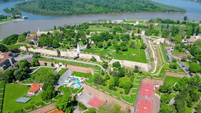 Aerial view of Belgrade where the Sava and Danube rivers meet. Visible landmarks include Kalemegdan Fortress (Beogradska tvrđava), city bridges, and U&scaron;će Park &mdash; a perfect urban-meets-nature panorama