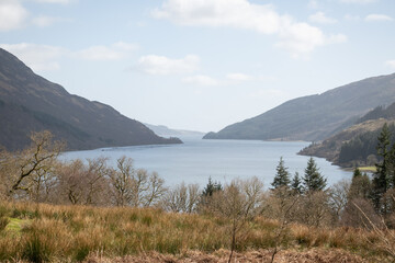 stunning rugged rocky Scottish coastline landscape overlooking loch Striven into the clear cold blue water Firth of Clyde on a gorgeous sunny day.