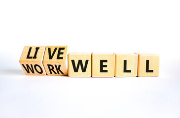 Live or work well symbol. Concept words Live well Work well on wooden cubes. Beautiful white table white background. Business and live or work well concept. Copy space.