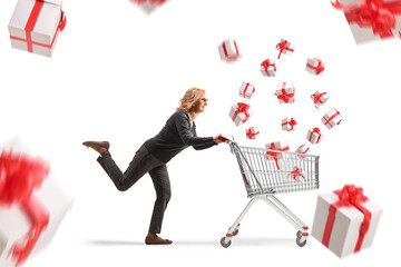 Full length profile shot of a mature woman running with flying presents and a shopping cart