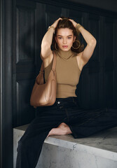 Fototapeta premium Girl model in the interior in stylish clothes with a bag. style fashion.