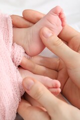 Mother with her little baby on bed indoors, top view