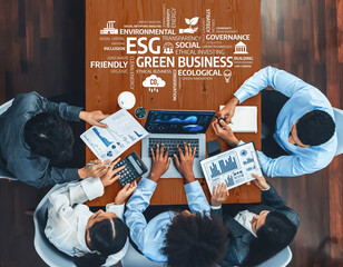 A diverse team is collaborating on green business strategies, analyzing data and sharing insights on sustainability and ethical practices in a modern office environment. Amity