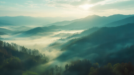Obraz premium Morning mist envelops Great Smoky Mountains with sunlight breaking through fog over hills