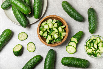 Cucumber on wooden background. Slice of cucumber on background. Fresh organic green cucumbers gherkin. Vegan. Salad ingredient. Farm vegetables. Cut vegetables with knife. Space for text. Copy space