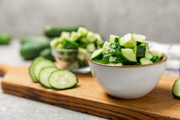 Cucumber on wooden background. Slice of cucumber on background. Fresh organic green cucumbers gherkin. Vegan. Salad ingredient. Farm vegetables. Cut vegetables with knife. Space for text. Copy space