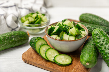 Cucumber on wooden background. Slice of cucumber on background. Fresh organic green cucumbers gherkin. Vegan. Salad ingredient. Farm vegetables. Cut vegetables with knife. Space for text. Copy space