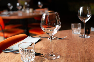 Stylish table setting in a cozy restaurant with dishes and furniture