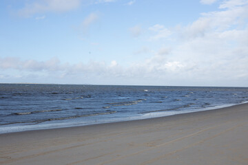 Winter landscape with snow-covered dunes at the Dutch North Sea coastline under a blue sky, Noord Holland, Netherlands