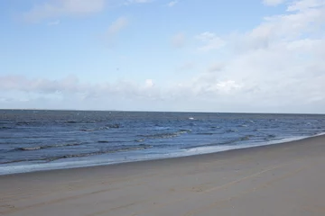 Winter landscape with snow-covered dunes at the Dutch North Sea coastline under a blue sky, Noord Holland, Netherlands