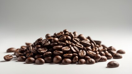 Obraz premium Isolated white background featuring a heap of aromatic roasted coffee beans