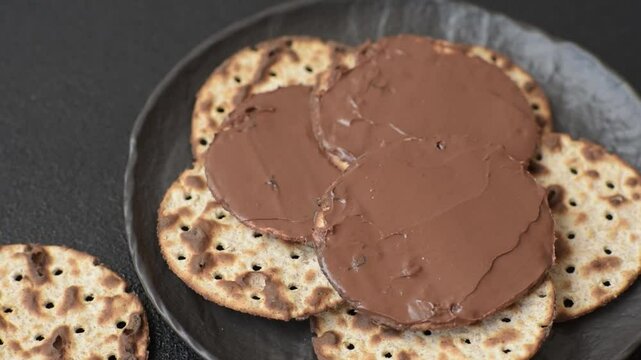 Matzah with chocolate paste for the Jewish holiday of passover for the festive table
