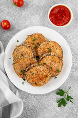 Baked garlic crispy eggplant with tomato sauce on a plate. Vegetarian food. Selective focus, top view.