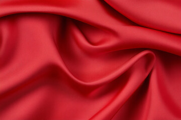 Obraz premium Bright red silk fabric draped elegantly over a monochrome background creating a vibrant contrast