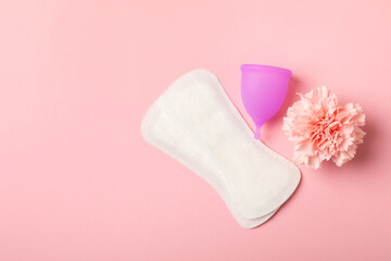 Menstrual cup on a bright background. Sanitary napkins, tampons and menstrual cup.Concept of...