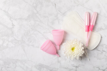 Menstrual cup on a bright background. Sanitary napkins, tampons and menstrual cup.Concept of...