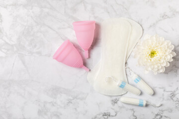 Menstrual cup on a bright background. Sanitary napkins, tampons and menstrual cup.Concept of...