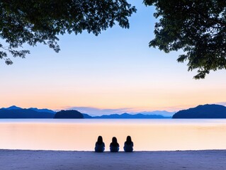 Friends admire sunrise on beach