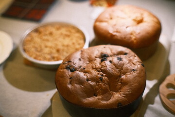 A muffin sitting on top of a table next to a bowl of food weather: . mood: neutral and natural.