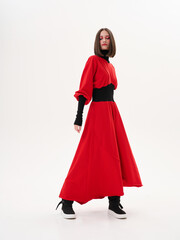 Portrait of a girl model in stylish clothes, in the studio on a light background.