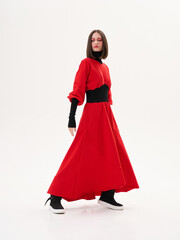 Fototapeta premium Portrait of a girl model in stylish clothes, in the studio on a light background.