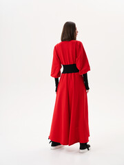 Portrait of a girl model in stylish clothes, in the studio on a light background.